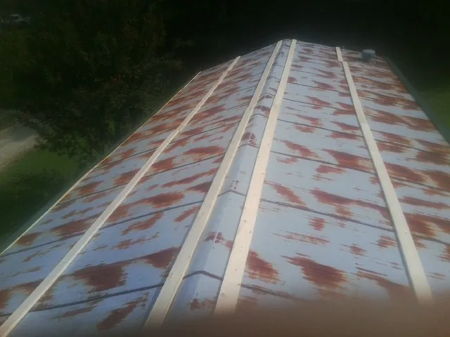 Rusted metal roof panels with new wood purlins before replacement — Storm Damage Roof Repair in Peach Bottom by Roofing Brothers
